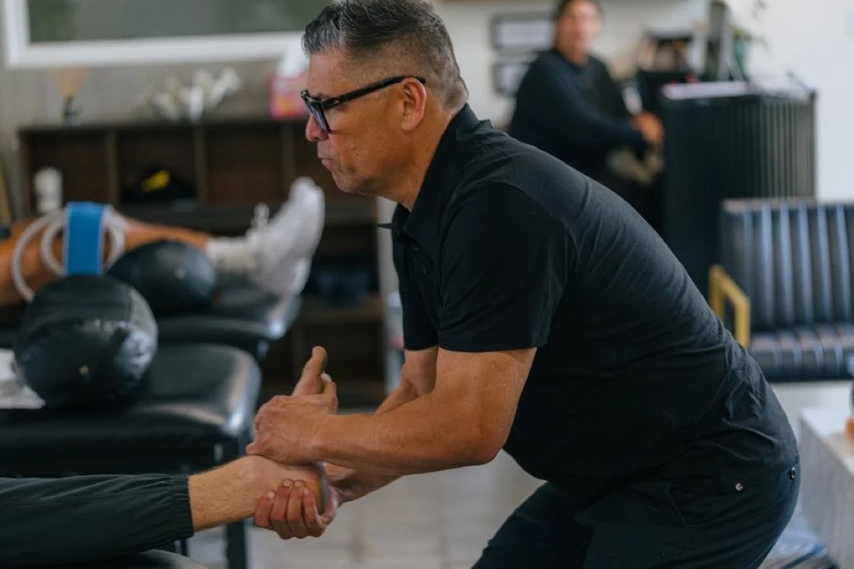 A Range physical therapist working on a patient's wrist